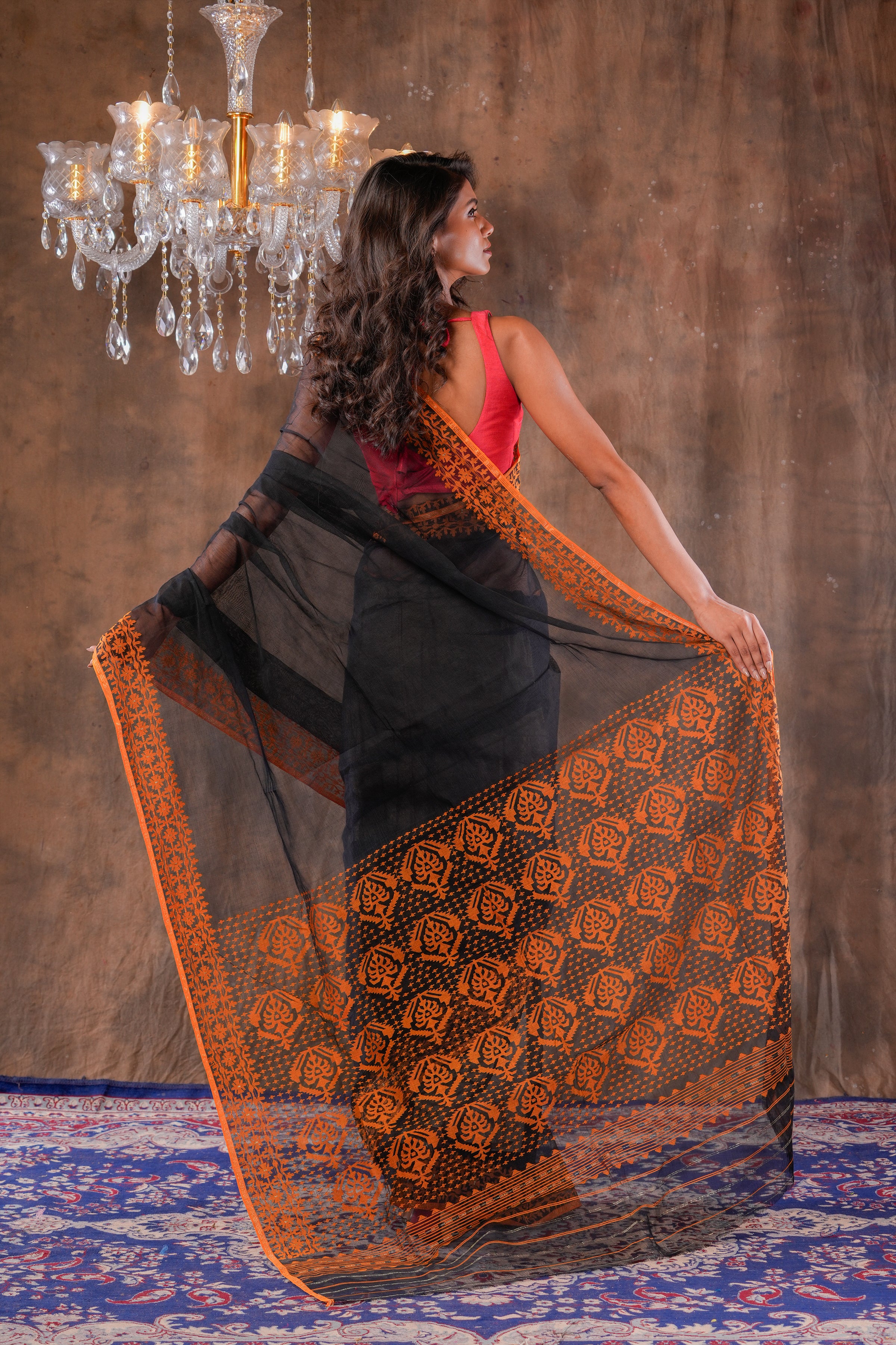 Handwoven Black Dhakai jamdani with orange border saree