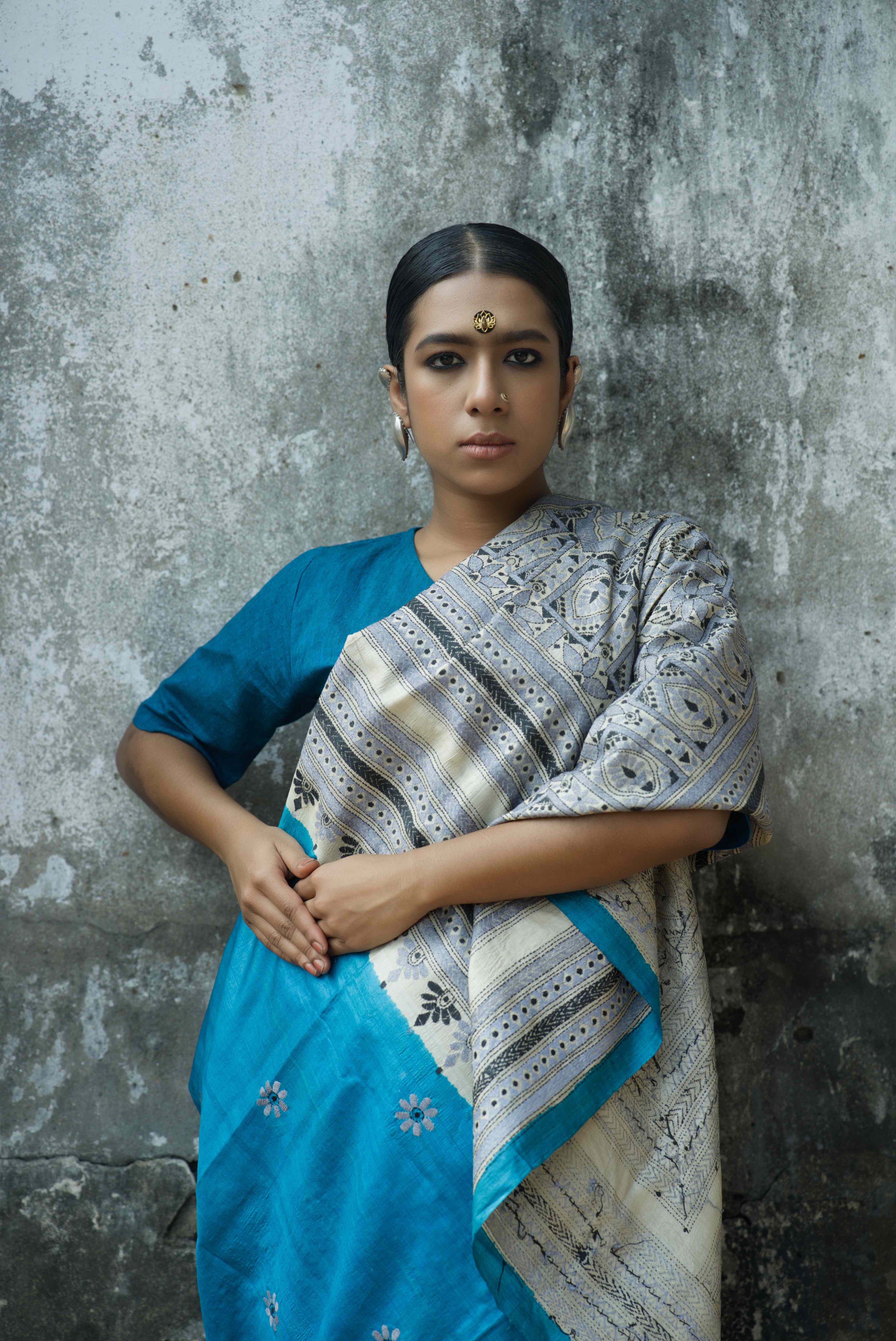 Handwoven blue Tussar saree with Kantha work draped over shoulder