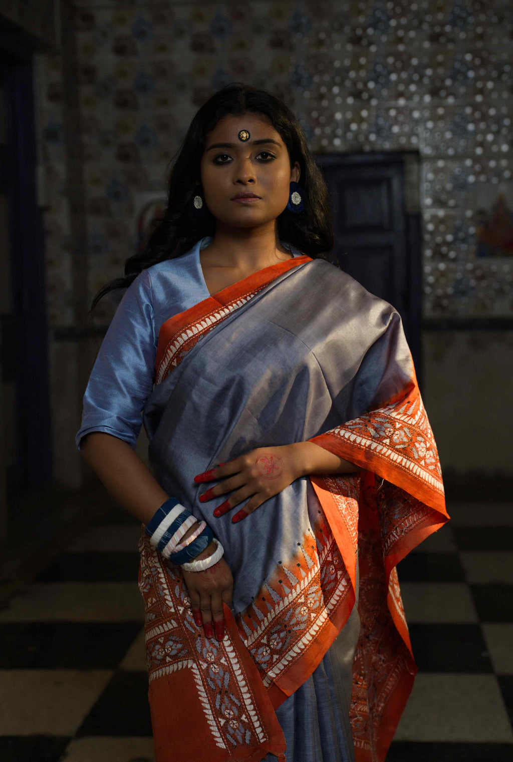 Handwoven grey Tussar saree with Kantha work — orange and white patterns